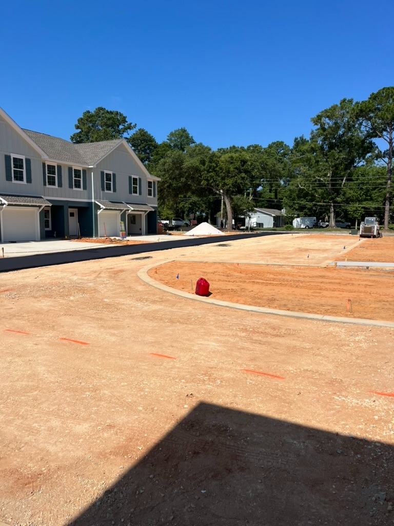 Multifamily residential site with formed concrete curb and adjacent grading