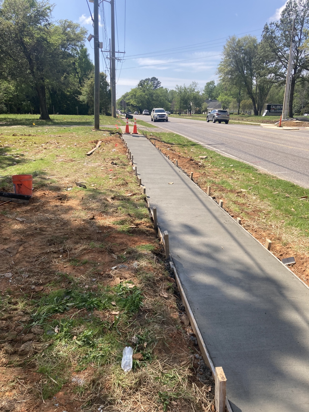 Freshly poured concrete sidewalk along a Baldwin County roadway